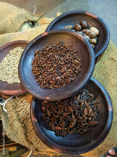 Wallpaper Mural Assorted spices displayed in rustic wooden bowls, including cloves, star anise, nutmeg, and coriander seeds Torontodigital.ca