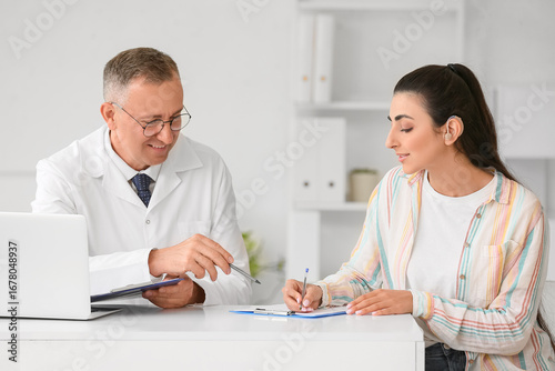 Young woman with hearing ai...
