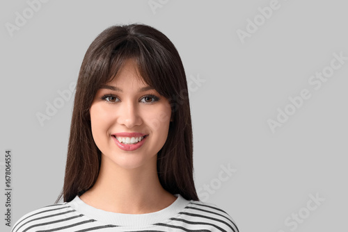 Smiling young woman on ligh...