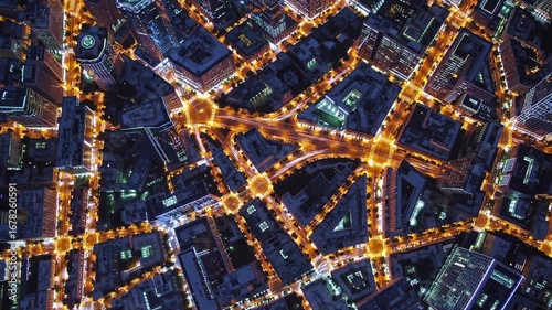 Kaleidoscopic cityscape pattern forming a modern urban design illuminated by street lights at night, creating a visually appealing and intricate abstract representation of a metropolis