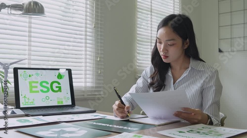 Asian businesswoman analyzing esg environmental social and governance reports
