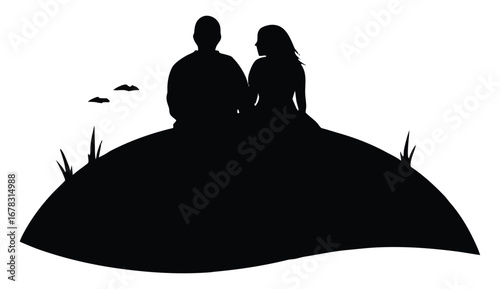 Silhouette of romantic couple sitting on a hill together in nature