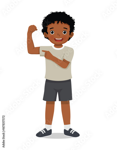 Little African boy showing his strong muscle arm fist
