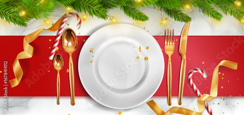 Christmas plate arrangement with white dinnerware, golden cutlery and candy cane on festive red tablecloth decorated by pine branches. Holiday table setting with ribbon for seasonal dining celebration