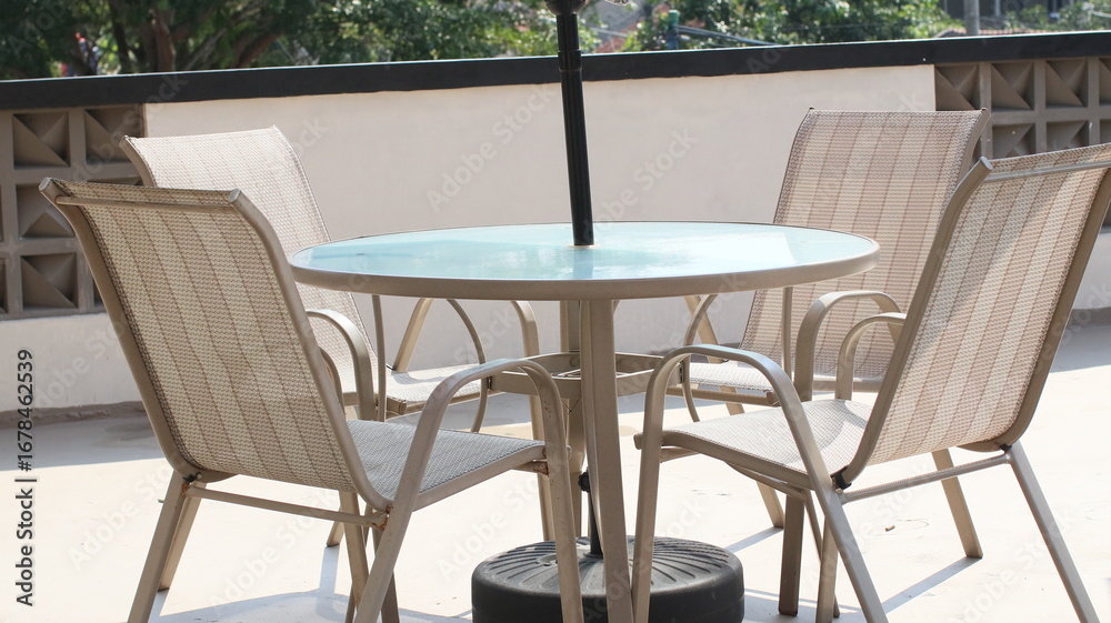 Fototapeta premium Chairs and tables in a coffee cafe are neatly arranged on the rooftop.