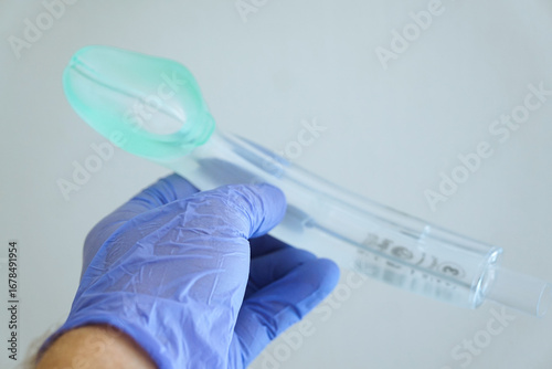 Tableau sur toile Hand in blue medical glove holding an I-gel supraglottic airway tube (size 3), medical equipment for anesthesia and emergency airway management