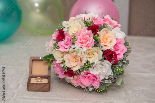 Soap Flower bouquet, arranged in a colorful composition, next to a wooden box with rings. Bride's bouquet, 2026