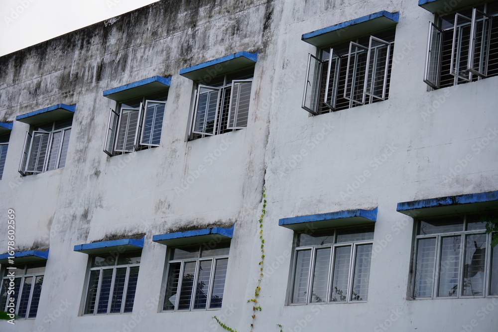 Obraz premium Weathered Apartment Building Facade with Bars
