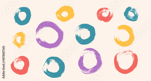 Circles brush set. Polka dots multi colors elements. Spray paint hand drawn round forms isolated on beige background. Grunge brush textured circular shapes. Kids scribbles. Vector illustration.