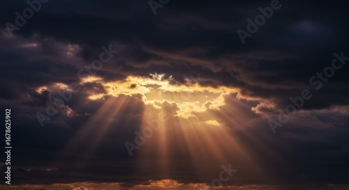 Dramatic golden light breaking through dark clouds