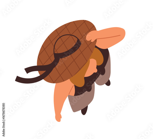 Woman holding hat in wind, top down view. Female standing in windy weather, h...