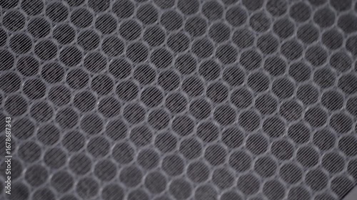 A macro shot of a new activated carbon filter for an air purifier. The honeycomb structure is filled with carbon pellets designed to absorb odors, gases, and volatile organic compounds (VOCs).