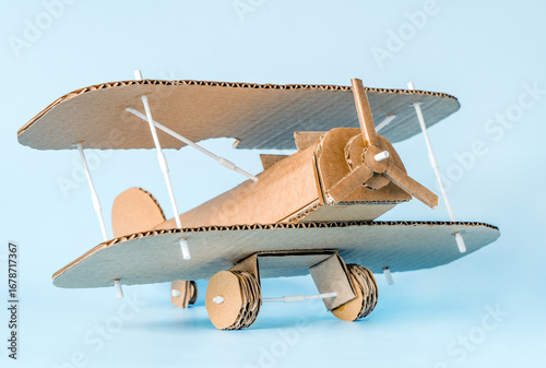 Creative handmade cardboard airplane craft on blue background for kids and hobby inspiration