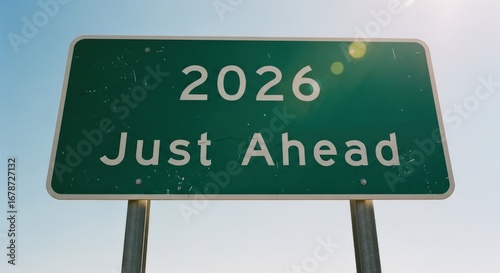 2026 Just Ahead Green road sign against a clear blue sky, future perspective