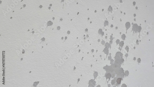 Fotografie Splattered gray paint forms an abstract constellation on barren drywall, evoking