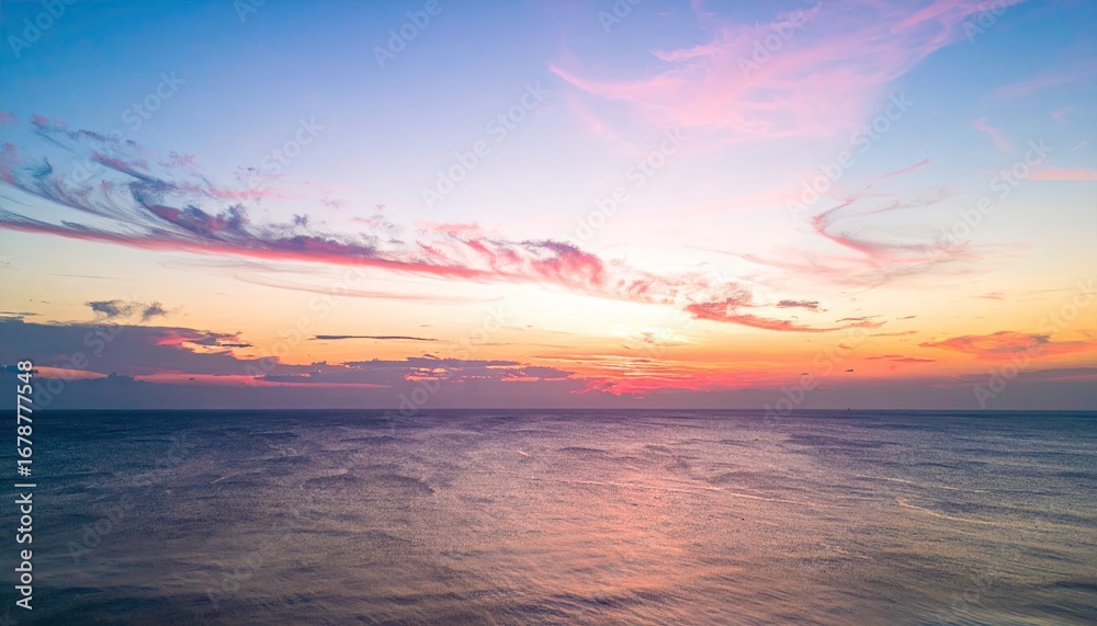 Fototapeta premium Serene Sunrise Over Open Ocean with Soft Pink And Orange Sky