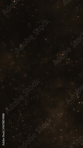 Luxury background with glittering shiny gold particles and shimmering bokeh light. Elegant golden vertical background ideal for glamorous events, award ceremonies or talent shows. 