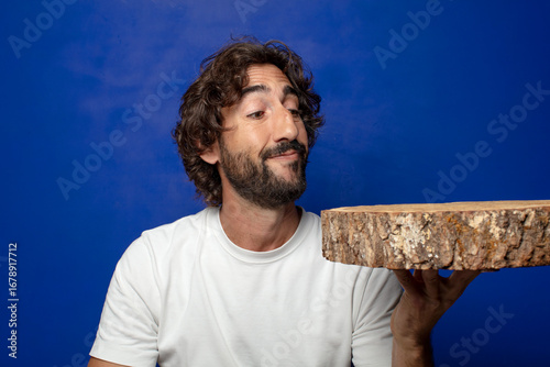 young adult bearded man with a wooden copy space