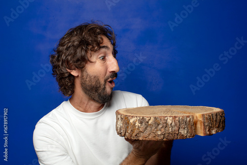 young adult bearded man with a wooden copy space