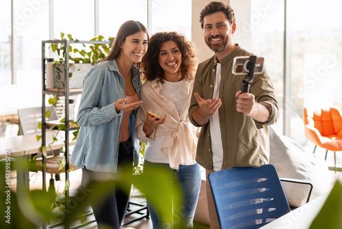 Photography Startup team creating online content with smartphone gimbal in modern office