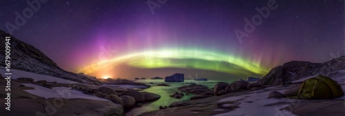 Stunning Aurora Borealis Over Icebergs and River with Tents in Remote Arctic Landscape at Night