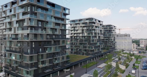 Aerial view of a premium residential complex in Katowice, Poland, with modern glass balconies, landscaped surroundings, and contemporary architectural design in a growing urban neighborhood.