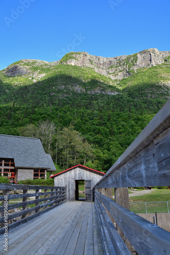 The Acropole des Draveurs Erables mountain in Hautes Gorges de la Riviere Malbaie National Park, Charlevoix Quebec Canada. SEPAQ. Wooden bridge above dam.
