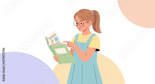 Young Woman With Glasses Is Pointing At An Image While Reading A Book