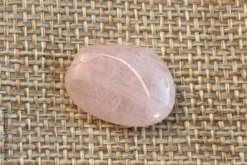 Several pieces of polished pink quartz on textured background. Minimal color still life photography