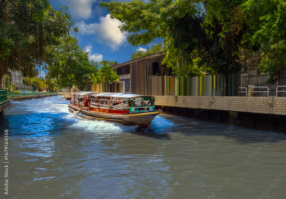 Fototapeta premium Ferry boat going through a Canal Khlong in Thai running from Asoke Soi 21 Sukhumvit Rd NANA to Siam and Platunam in BKK Bangkok Thailand