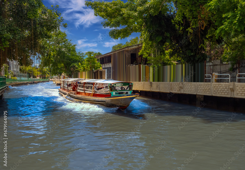 Fototapeta premium Ferry boat going through a Canal Khlong in Thai running from Asoke Soi 21 Sukhumvit Rd NANA to Siam and Platunam in BKK Bangkok Thailand