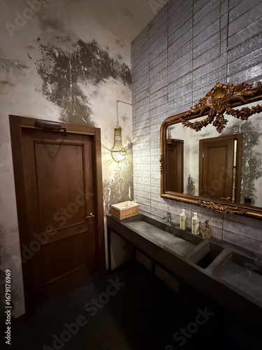 Vintage industrial bathroom interior with ornate mirror