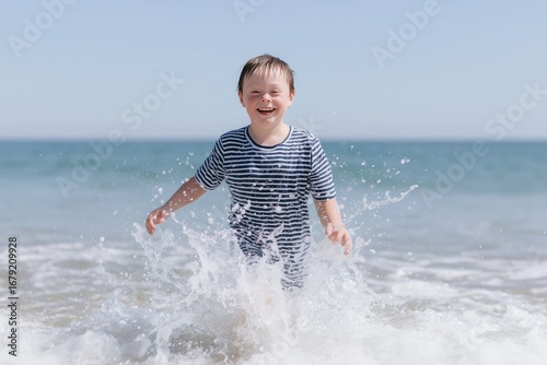 Child splashing in ocean waves at a beach. Represents themes of joy, family, and carefree spirit. Ideal for summer campaigns, travel, and lifestyle content.