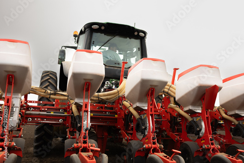 Fototapeta Tractor and seeder for sowing corn