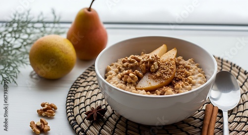  a bowl of warm, spiced pear and oat porridge, garnished with toasted walnuts and a sprinkle of brown sugar. A cozy, woven placemat sits beneath it, with a hint of a snow-covered window in the backgro