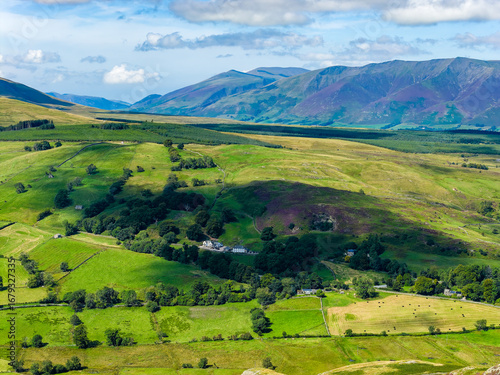 Vibrant green fields and farms of the English countryside on a sunny summer day