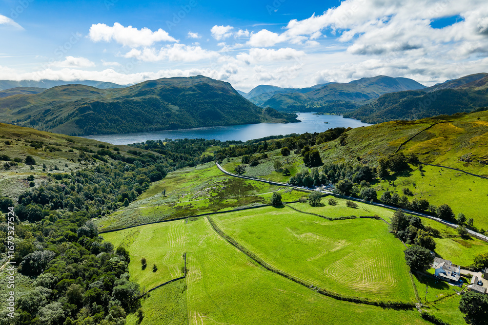 Fototapeta premium Rural landscape of the English Lake District with farmland, hills, and Ullswater