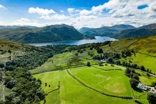 Rural landscape of the English Lake District with farmland, hills, and Ullswater