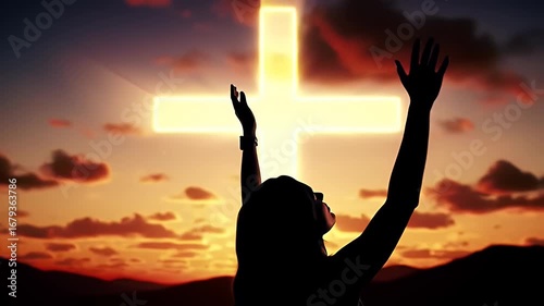 Woman Silhouette Raising Hands Towards Radiant Cross at Dramatic Sunset Sky and Dark Mountains