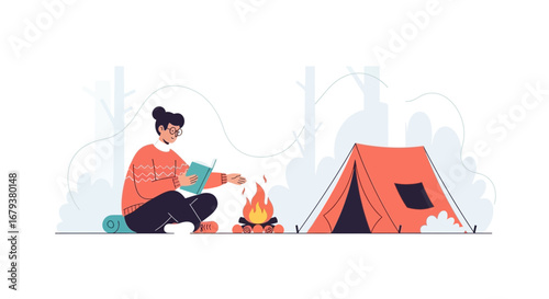 Woman camping, reading a book near a campfire by the tent, resting in nature