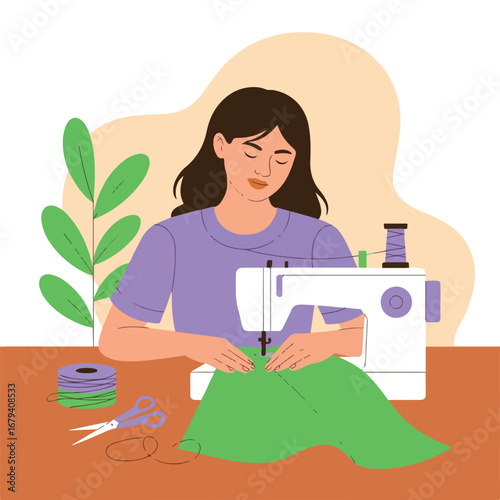 Woman sewing fabric with a sewing machine in her workshop at home