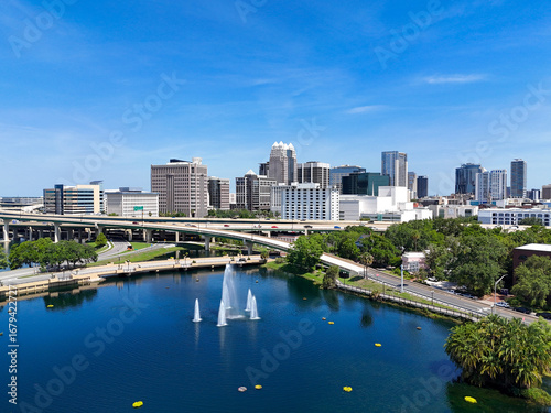 View looking over the Lake Lucerne fountain and the downtown Orlando skyline in Orange County, Orlando, Florida, USA. 