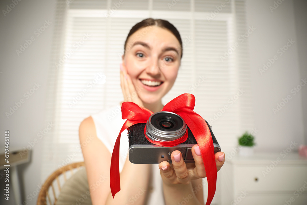 Fototapeta premium Dreams come true. Woman with new gifted camera at home, selective focus