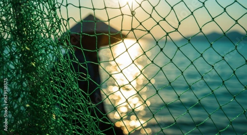 Green Fishing Net with Sunlit Ocean Background, Abstract Texture, and Lens Flare.