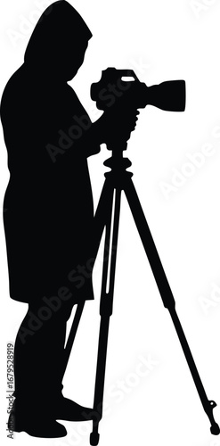 Silhouette of a photographer with a camera on a tripod