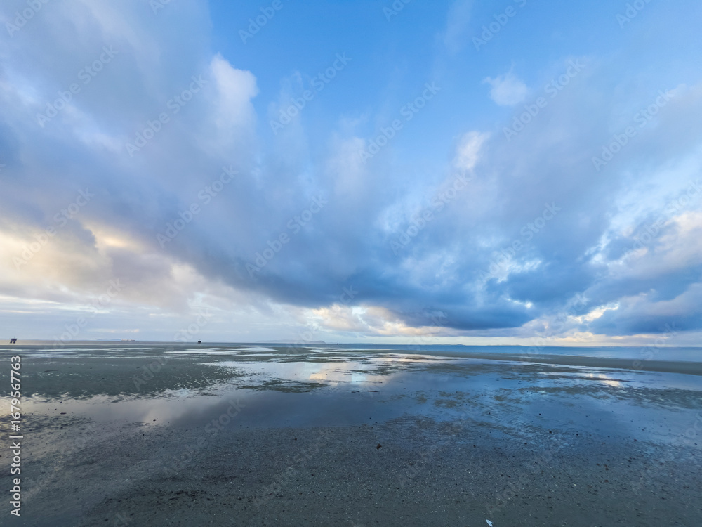 Fototapeta premium Low Tide Reflections under a Dramatic Cloudy Sky