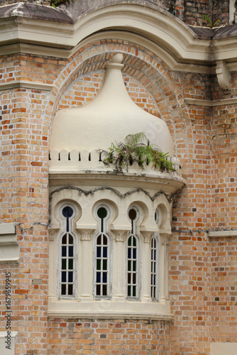 Canvas Print Bay window (oriel) is a protruding decorative window/niche in a facade with a dome and arched windows on a brick facade in Kuala Lumpur, Malaysia