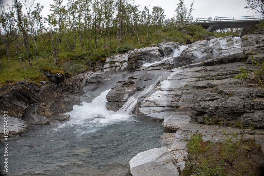 Obraz premium Silverfallet waterfall near the mountain village of Bjorkliden in Kiruna municipality, northern Sweden.