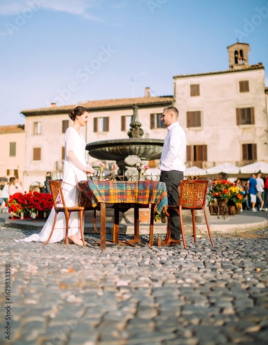 Couple dining outdoors in a European square