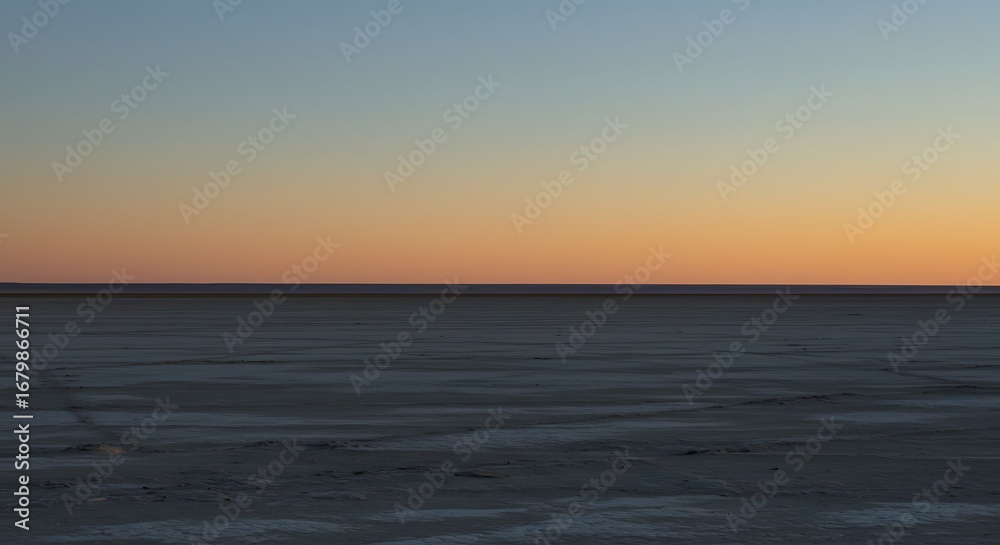 Obraz premium Vast Desert Plain Under Gradient Sunset Sky at Dusk